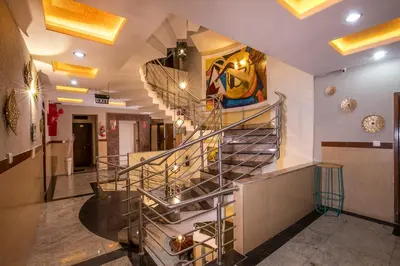 a metal spiral staircase in a building at Aishwarya Residency in Mysore