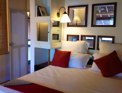 a bedroom with a bed with red and white pillows at Les 3 Elephants in Cherai Beach