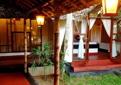 a house with a bedroom and a bed in it at Les 3 Elephants in Cherai Beach