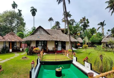 a house with a pool in front of it at Les 3 Elephants in Cherai Beach