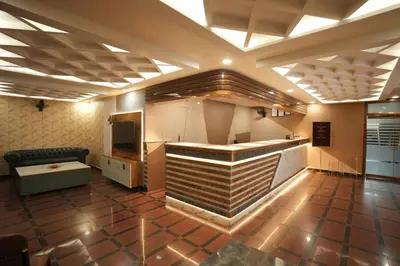 a large room with a bar in the middle at Hotel Kairali in Palakkad