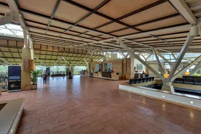 an empty lobby of a building with a large ceiling at Club Mahindra Virajpet, Coorg in Virajpet
