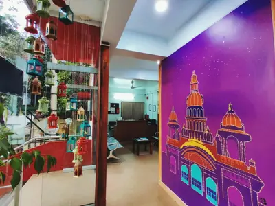 a room with a wall with a painting of a building at Raccoon Rooms in Mysore