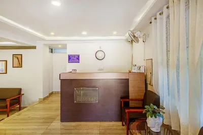a waiting room with a podium and a clock on the wall at Treebo New Redfern, Madikeri in Madikeri