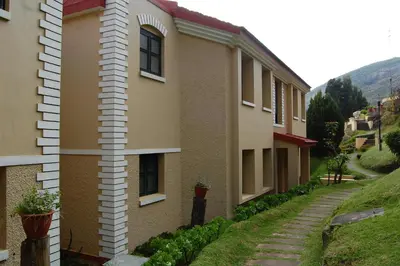 a building with potted plants on the side of it at Mountain Retreat - A Hill Country Resort in Ooty