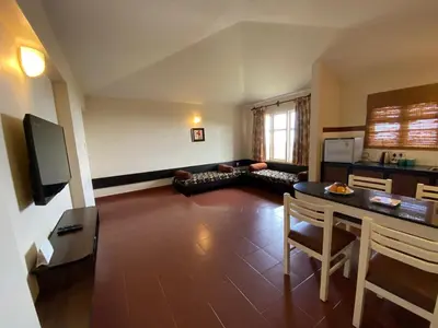 a living room with a couch and a table at Mountain Retreat - A Hill Country Resort in Ooty