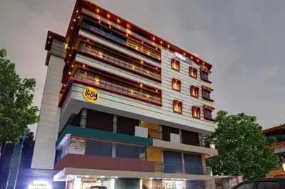 a tall white building with lights on it at Hotel Fathima Palace in Kottakkal