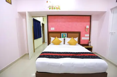 a bedroom with a large white bed with yellow pillows at Base9 Cochin Airport Hotel in Nedumbassery