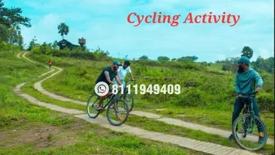 a group of people riding bikes on a dirt road at Shining Caves Resort in Varagampadi
