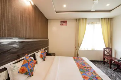 a hotel room with a bed and a window at FabHotel Prime Suloka Towers - 500m from View point, Kaveri River in Kushālnagar