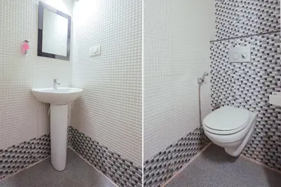 a bathroom with a toilet and a sink at FabHotel Prime Suloka Towers - 500m from View point, Kaveri River in Kushālnagar