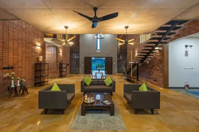 a living room with two couches and a tv at SaffronStays Riverstone 3-BR Riverside Villa with Farm Views in Seringapatam