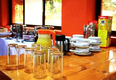 a wooden counter top with glasses and cups on it at Coorg amodhini in Madikeri