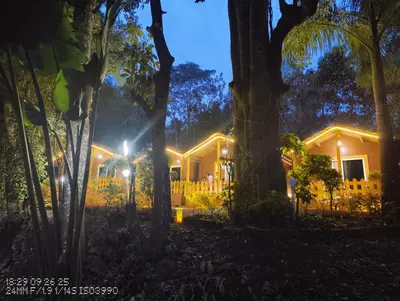 a house in the woods at night at Coorg amodhini in Madikeri