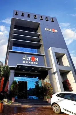 a car parked in front of a building at Hotel Wilton in Sultan Bathery