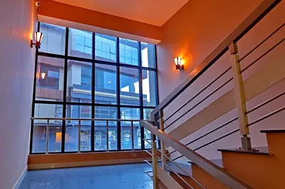 a staircase in a building with a large window at Hotel Wilton in Sultan Bathery