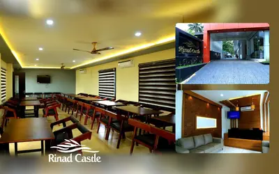 a restaurant with tables and chairs in a room at Royal Plaza Wayanad in Vythiri