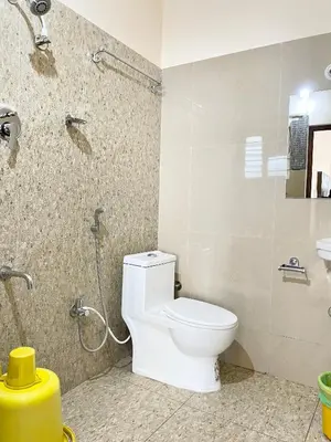 a bathroom with a toilet and a shower at The INN in Mysore