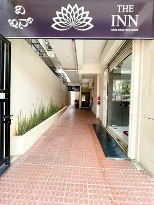 an empty hallway of a building with a purple sign at The INN in Mysore