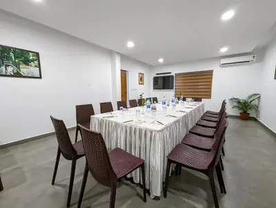 a dining room with a long table and chairs at Once Upon The River, Aluva - Near Cochin International Airport in Cochin