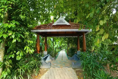 a walkway with a pavilion in a garden at Once Upon The River, Aluva - Near Cochin International Airport in Cochin