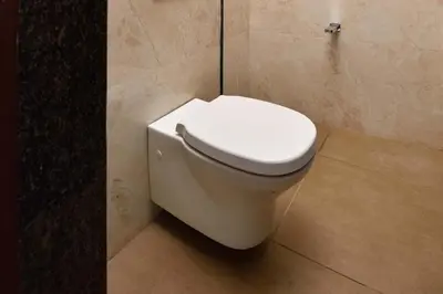 a bathroom with a white toilet in a room at Villa Sullivan by VEO - Part of StayVista in Ooty