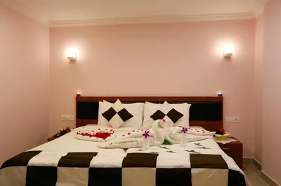a bedroom with a large bed with flowers on it at Luxora Hotel and Spa in Kozhikode