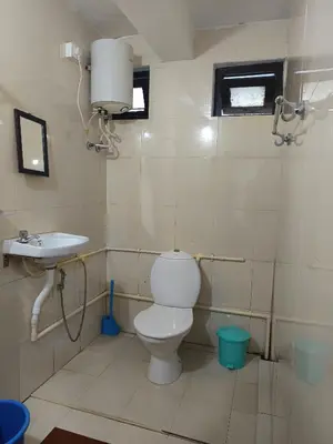 a bathroom with a toilet and a sink at Osprey individual Cottage in Ooty