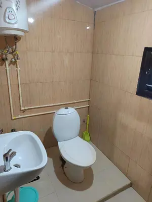 a bathroom with a toilet and a sink at Osprey individual Cottage in Ooty