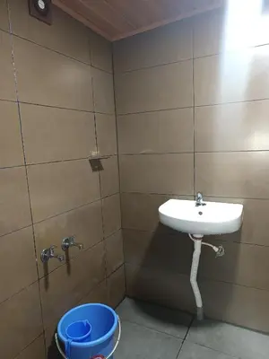 a bathroom with a sink and a toilet at Osprey individual Cottage in Ooty