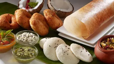 a table with various types of bread and dips at GAYATHRI HOTELS in Badagara