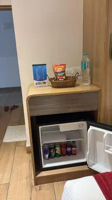 an open refrigerator with drinks inside of it at GAYATHRI HOTELS in Badagara