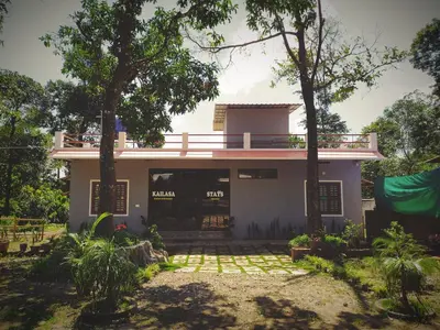 a house with a balcony on top of it at kailasa stays in Chekadi