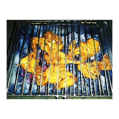 a group of food cooking on a grill at kailasa stays in Chekadi
