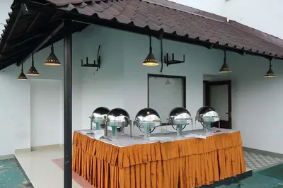 a row of bowls on a counter with lights at Hotel CLOUD 9 in Kotamangalam