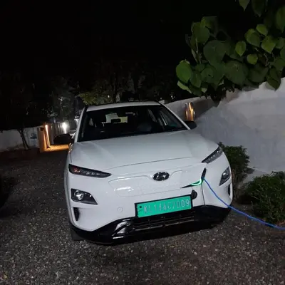 a white car parked next to a wall at Nature Villa Kochi in Alwaye