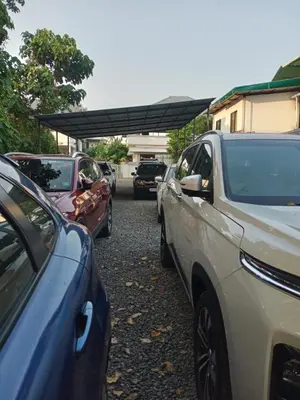 a group of cars parked in a parking lot at Nature Villa Kochi in Alwaye