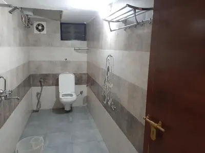 a bathroom with a toilet and a sink at Nature Villa Kochi in Alwaye