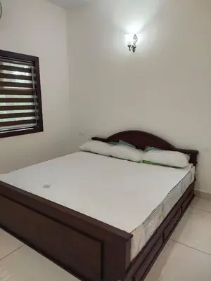a bed sitting in a room with at Green Garden Lotus in Vythiri