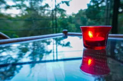 a red cup sitting on top of a table at Kuruva Island Resort And Spa - By KABINI BREEZE in Mananthavady