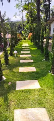 a garden with stepping stones in the grass at Viewpointwayanad in Mananthavady