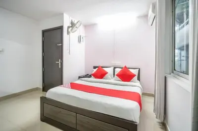 a bedroom with a large bed with red pillows at MALAPPURAM RESIDENCY in Malappuram