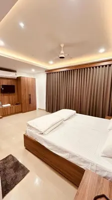 a bedroom with a large bed in a room at MALAPPURAM RESIDENCY in Malappuram