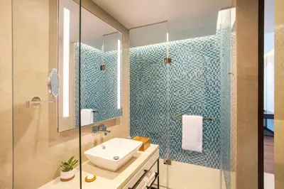 a bathroom with a sink and a glass shower at Hyatt Regency Thrissur in Trichūr