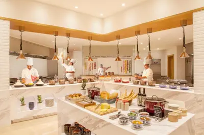 a group of chefs preparing food in a kitchen at Hyatt Regency Thrissur in Trichūr