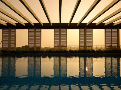 a view of a swimming pool at sunset at Hyatt Regency Thrissur in Trichūr