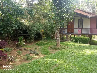 a house with a garden in front of it at Family villa is a hut style accommodation in Tariyod
