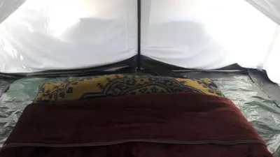 a pillow on a bed in a tent at Swiss Tents in Ooty, Tn in Ooty