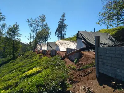 a house on top of a dirt hill at Swiss Tents in Ooty, Tn in Ooty