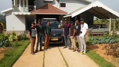 a group of men standing in front of a house at Chamayam Holiday Villa in Meenangadi